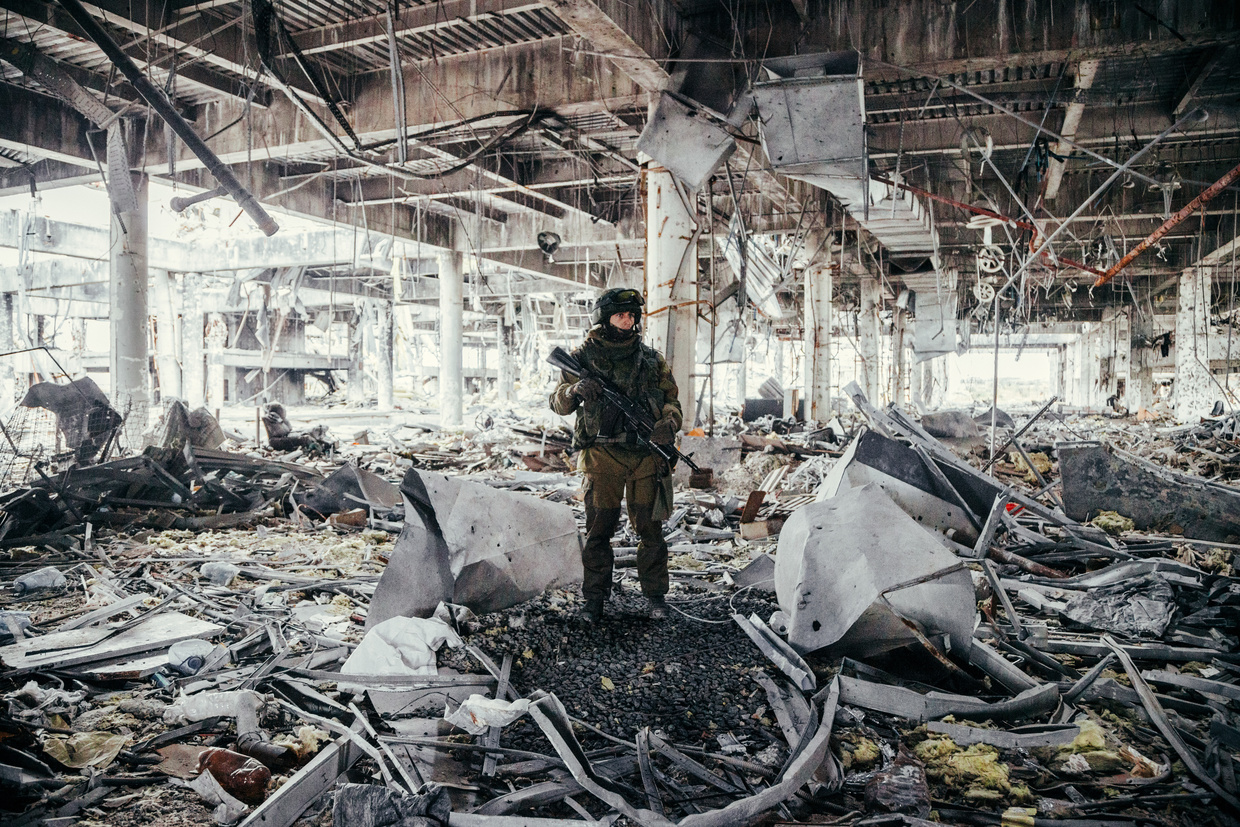 A soldier stands in the ruins of the Donetsk Airport