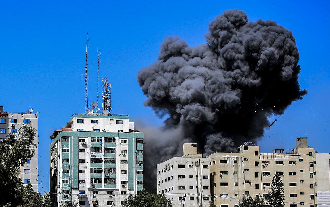 Smoke rises after an Israeli airstrike hits Al-Jalaa tower