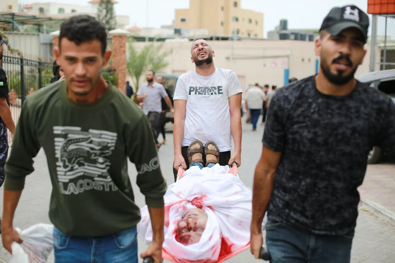 Palestinians transport an injured or killed person