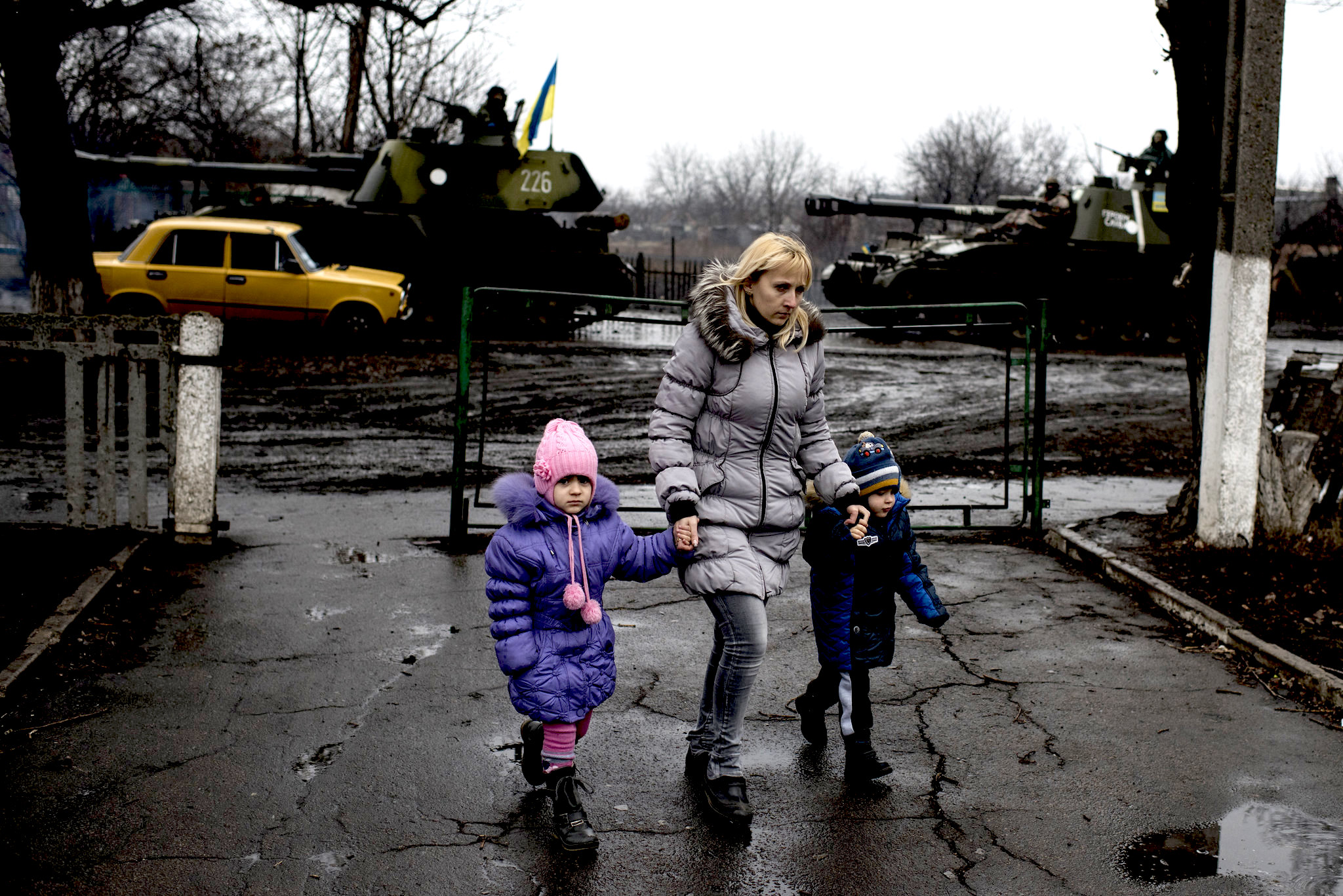 Civilians pass by heavy artillary in eastern Ukraine